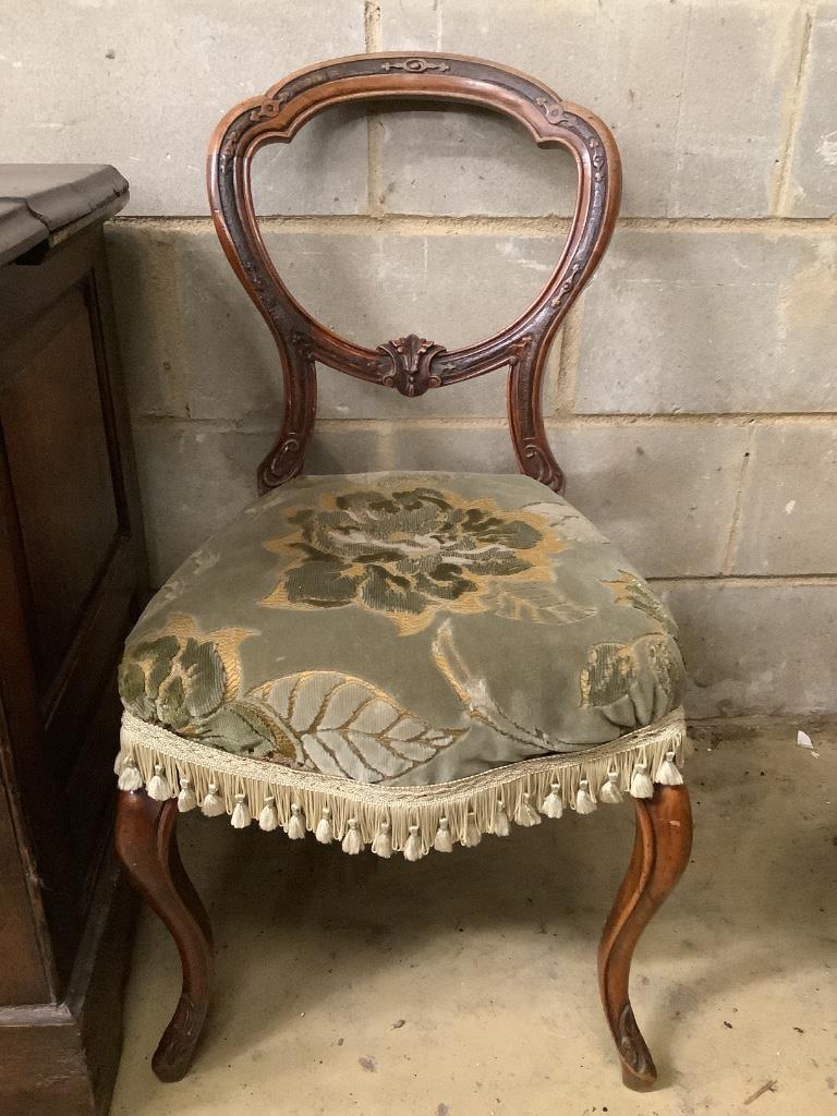 A Victorian ebonised and gilt upholstered nursing chair and pair of balloon back chairs